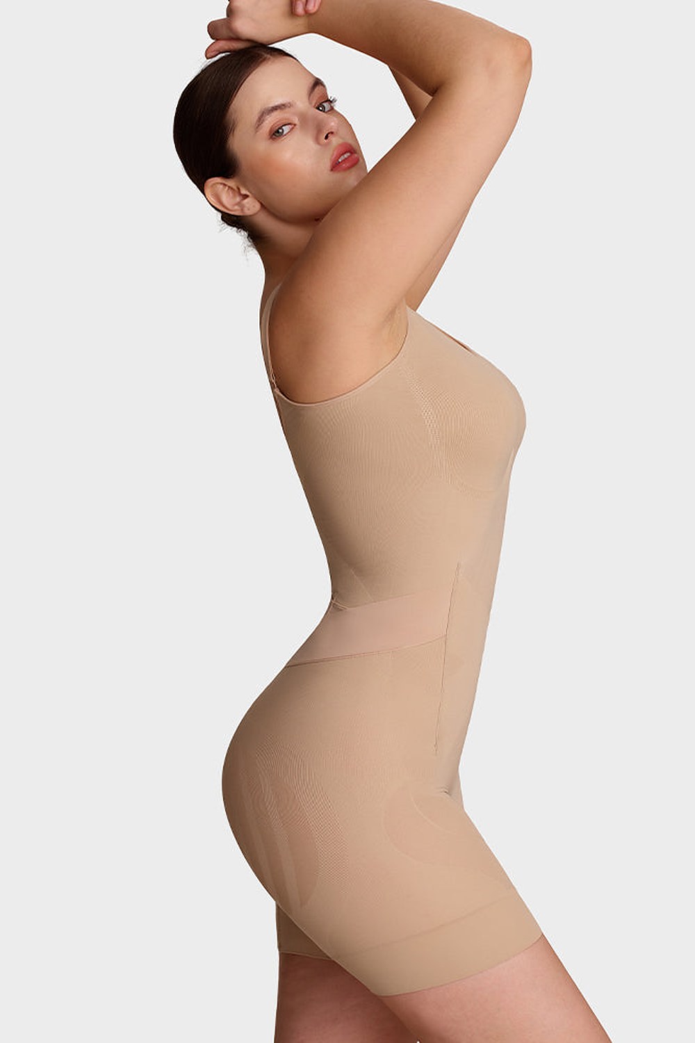 Nova Seamless Sculpting Bodysuit in Nude – side, arms raised